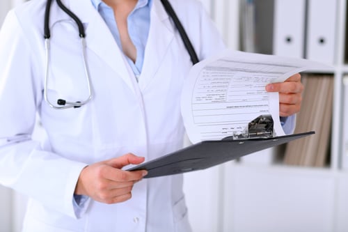 closeup-female-doctor-is-filling-out-application-form-medical-history