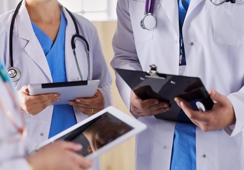 doctors-using-tablet-hospital-standing-office