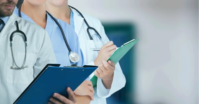 mid-section-team-medical-professionals-health-workers-against-hospital-background