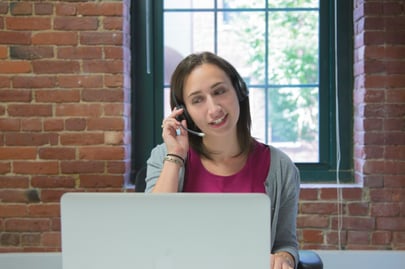 Woman working at a laptop delivering telemedicine for long-term care
